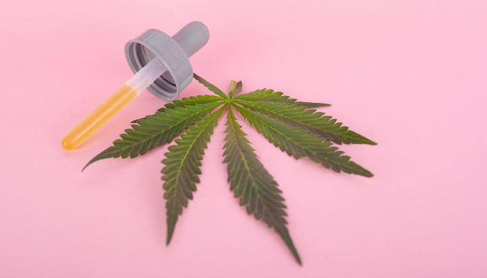 CBD oil dropper and cannabis leaf
