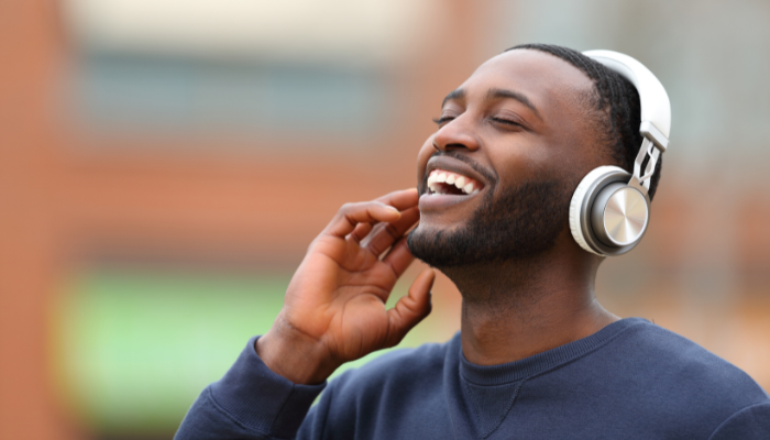 happy man wearing headphones and listening to music