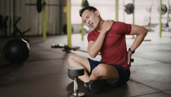 Man with muscle pain from overdoing exercise